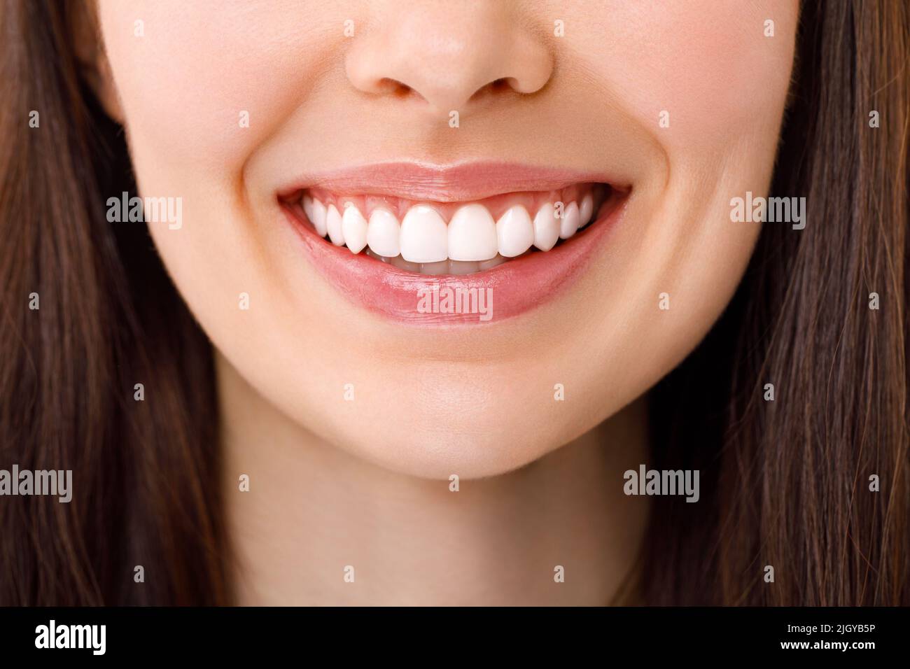 Eine schöne Frau lächelt. Ein Lächeln mit weißen Zähnen. Nahaufnahme des Bildes. Stockfoto