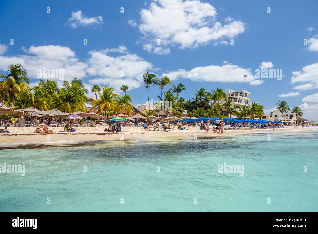 Sonnenbaden am weißen Sandstrand mit Sonnenschirmen, Bungalowbar und ... Sonnenbaden am weißen Sandstrand mit Sonnenschirmen, Bungalowbar und ...