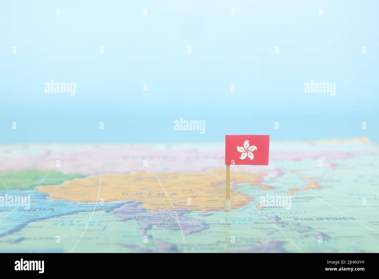 Selektiver Fokus der Hongkonger Flagge auf der Weltkarte. Hong Kong Land Lage und Souveränität Konzept. Stockfoto