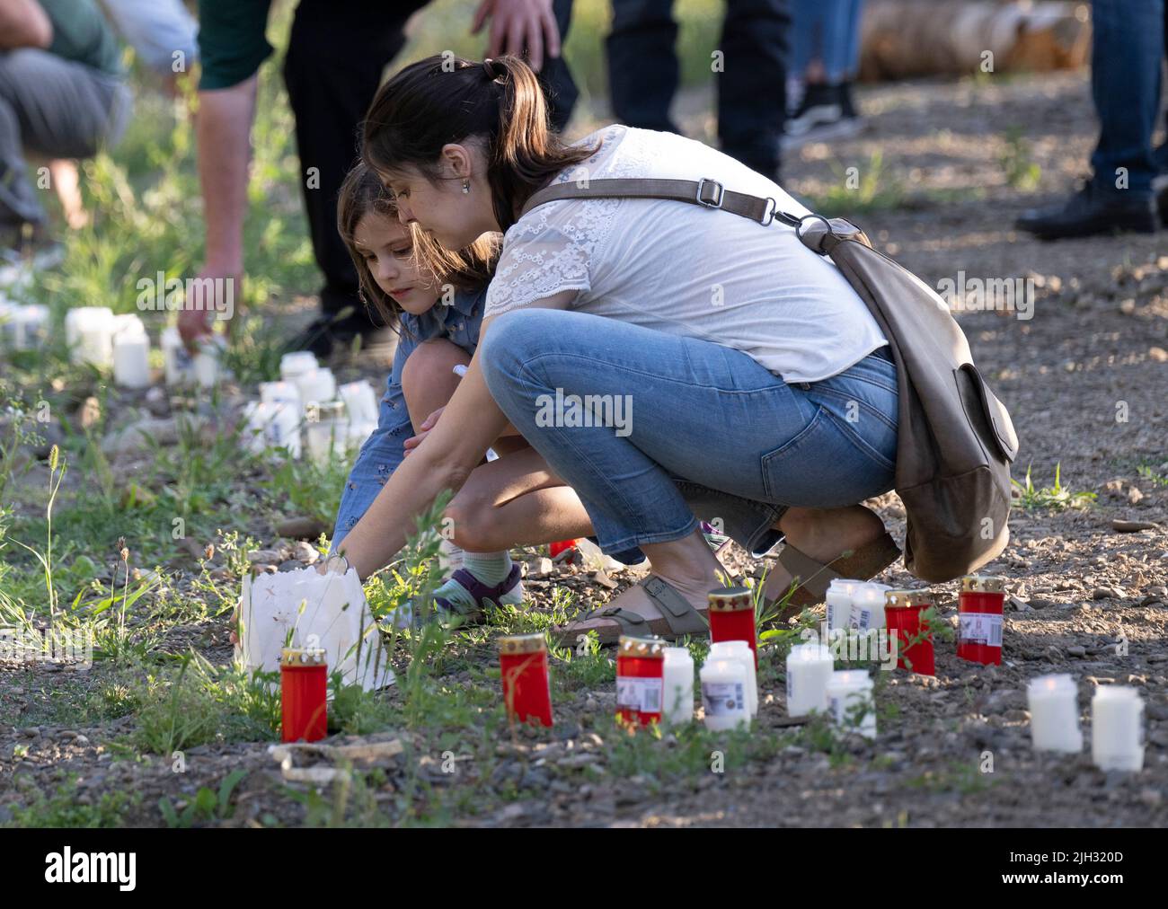 Schuld, Deutschland. 14.. Juli 2022. Zum Gedenken an die Opfer der Flutkatastrophe zünden Menschen Kerzen an den Ufern der Ahr in Schuld an. Schuld war von den Wassermassen extrem zerstört worden. Quelle: Boris Roessler/dpa/Alamy Live News Stockfoto