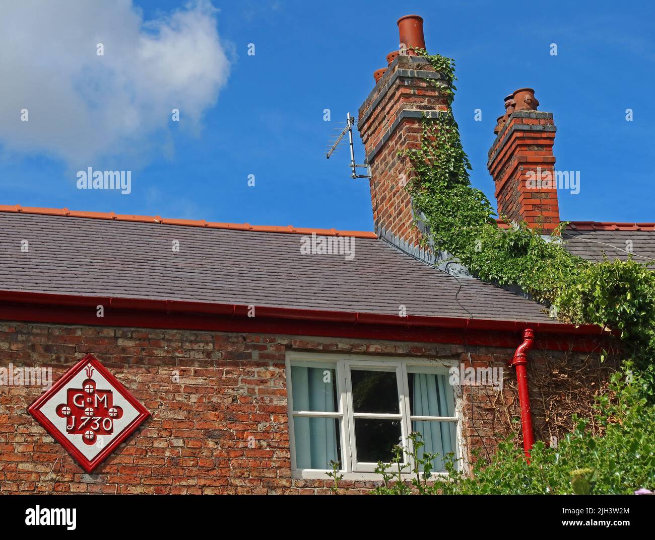 Dunham Massey Cottages, mit GM1730 an der Außenwand, Dunham, NT, Altrincham, Cheshire, ENGLAND, GROSSBRITANNIEN, WA14 4PE Stockfoto