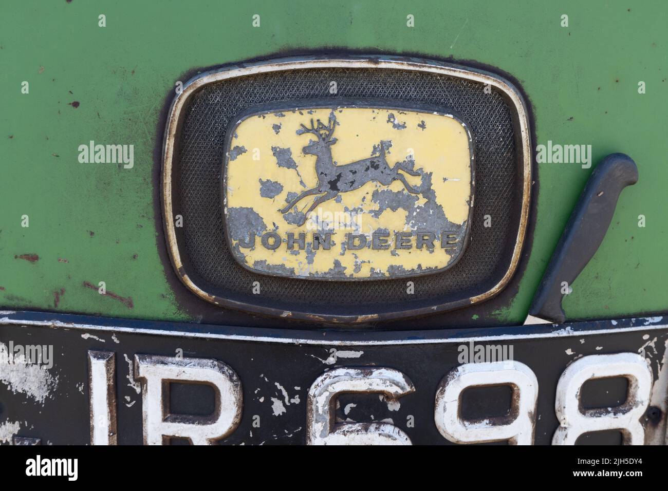 Detail des verwitterten John Deere-Traktorenlogos Stockfoto
