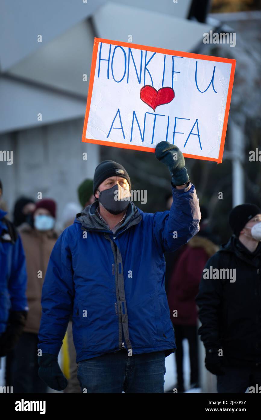 Ein Mann hält ein Schild mit dem Titel „Honk if you love Antifa“ bei einem Gegenprotest zum Konvoi „Freedom“ in Ottawa, Kanada. Februar 2022 Stockfoto