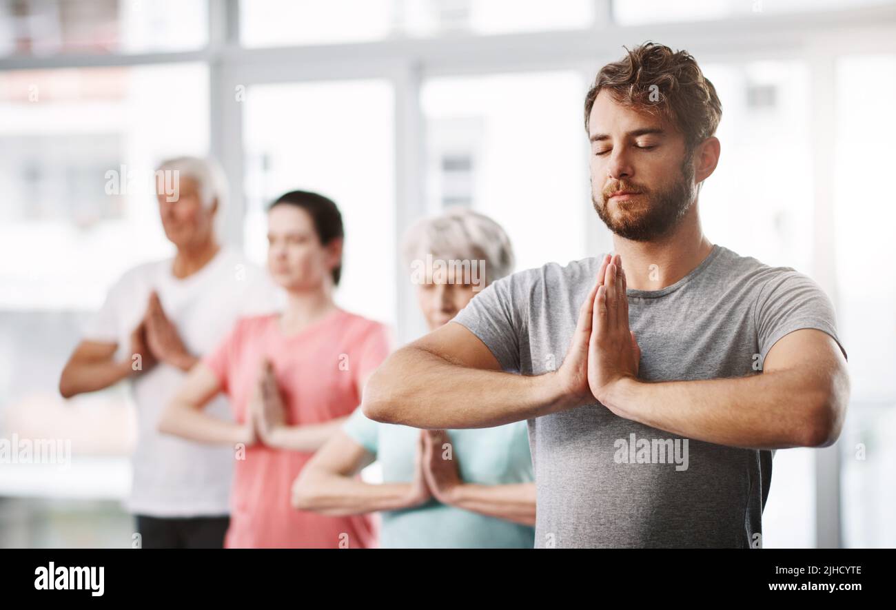 Nichts wird seinen Fokus brechen. Eine Gruppe von Menschen, die während des Yoga meditieren. Stockfoto