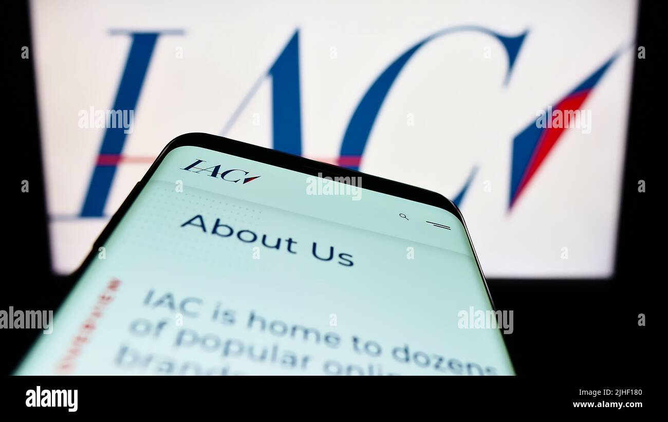 Smartphone mit Website des amerikanischen Medienunternehmens IAC InterActiveCorp auf dem Bildschirm vor dem Business-Logo. Konzentrieren Sie sich auf die obere linke Seite des Telefondisplays. Stockfoto