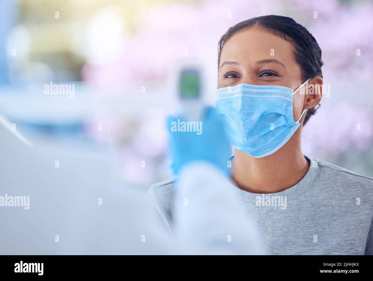 Arzt mit einem Temperaturthermometer. Arzt, der die Temperatur eines Patienten mit einem Monitor misst. Mitarbeiter, der die Ausrüstung zur Überprüfung eines verwendet Stockfoto