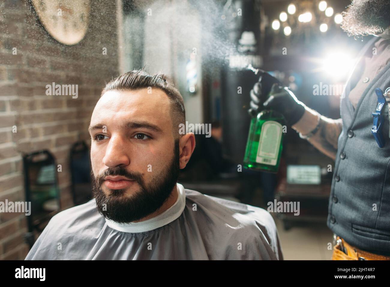 Letzter Schritt der Haarschnitt - Friseur Spray Client Stockfoto