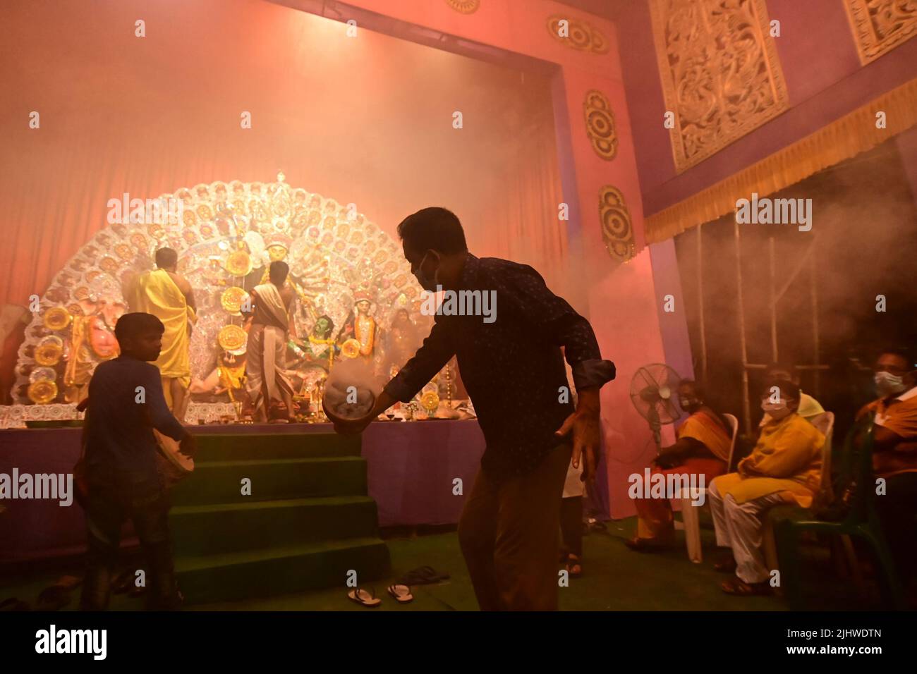 Howrah, Westbengalen, Indien -13. Oktober 2021 : Hindu-Anhänger tanzen Dhunuchi naach, vor der Göttin Durga als Ritual, während Dhaakis Dhaak spielen Stockfoto