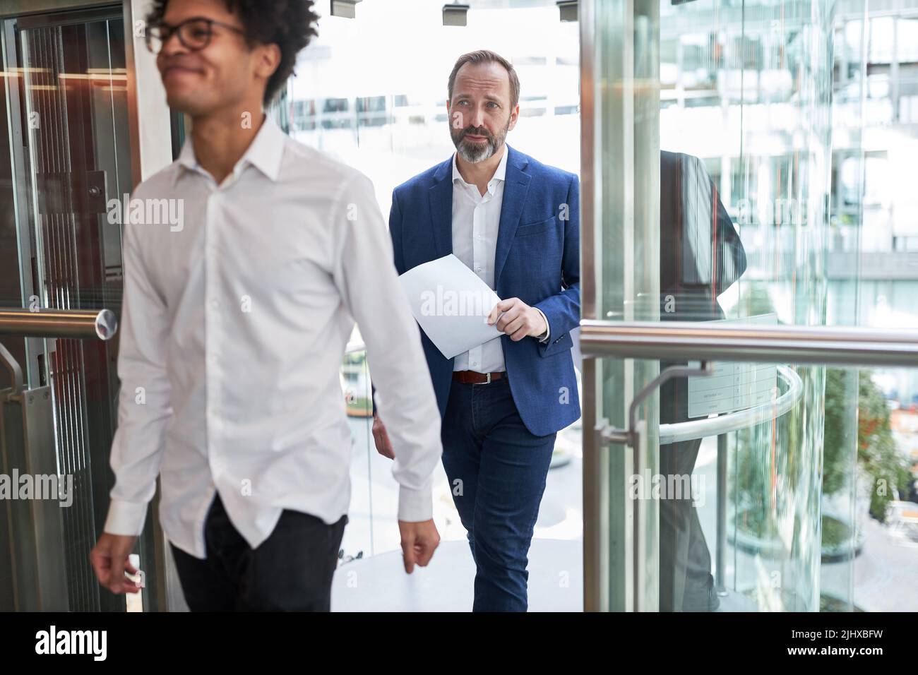 Junger Geschäftsmann und Senior Manager oder Berater auf dem Weg zu einem Meeting Stockfoto