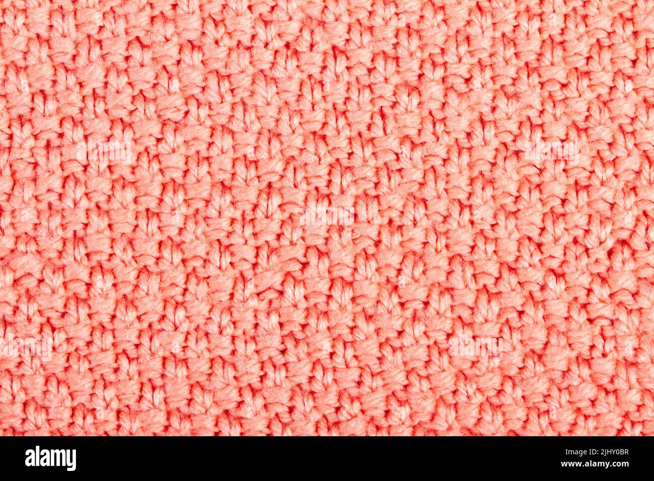 Rosa Gestrickter Stoffhintergrund oder Textur Stockfoto