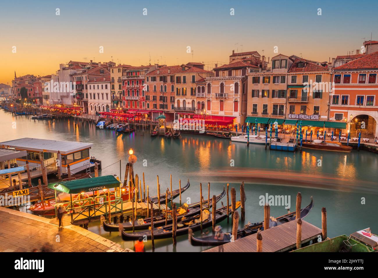 Venedig, Italien mit Blick auf Boote und Gondeln im Canale Grande in der Abenddämmerung. Stockfoto