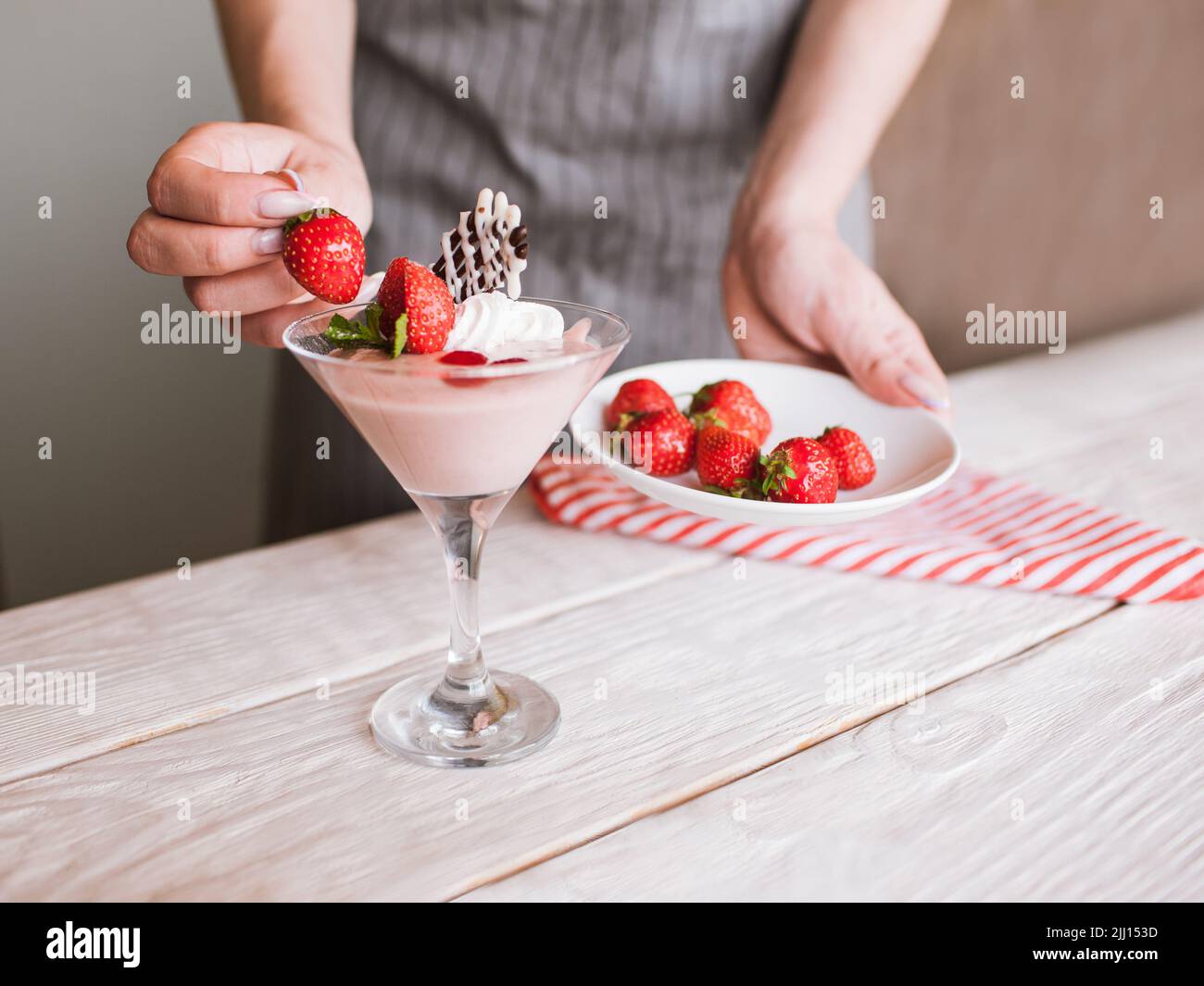 Cremige Erdbeere Dessert im Prozess der Dekoration Stockfoto