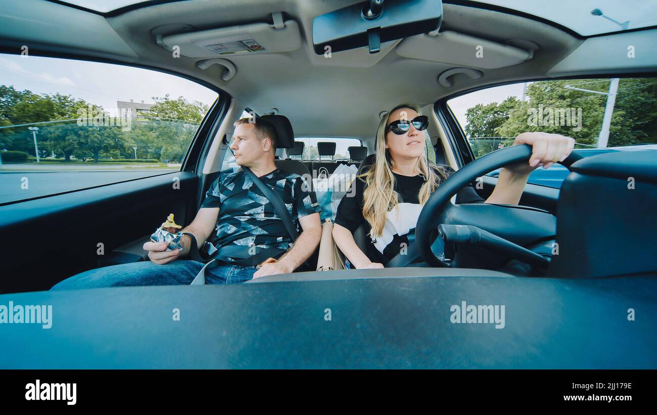 Ein Mann und eine Frau im Auto fahren durch die Stadt. Stockfoto