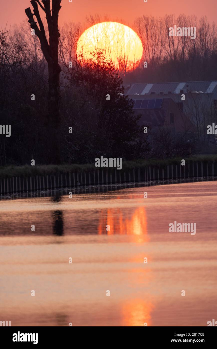 Sonnenuntergang orange See Wasser Reflexion Landschaft. Reflexion des Sonnenuntergangs Wasser. Blick auf den Sonnenuntergang über dem Fluss, orange. Sonnenuntergang Fluss Wasserspiegelung. Hochwertige Fotos Stockfoto