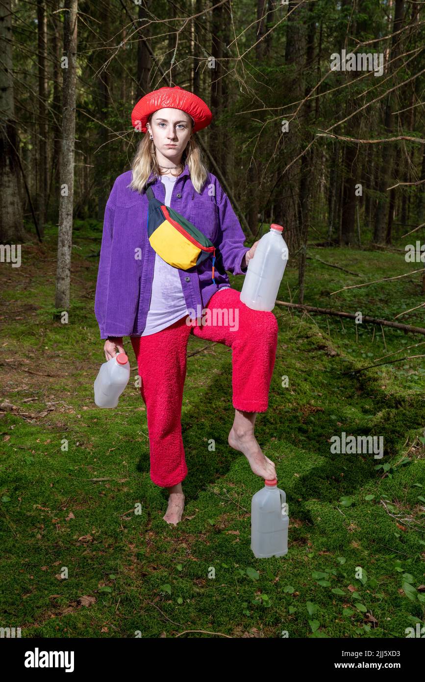 Frau mit Gallonen-Containern im Wald Stockfoto