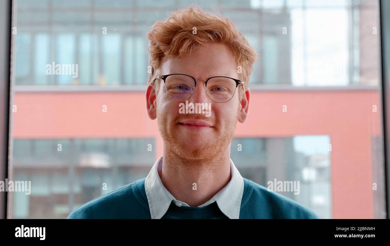 Junger irischer Ingwer in einer Brille, der die Hände auf dem Brustportrait kreuzt Stockfoto