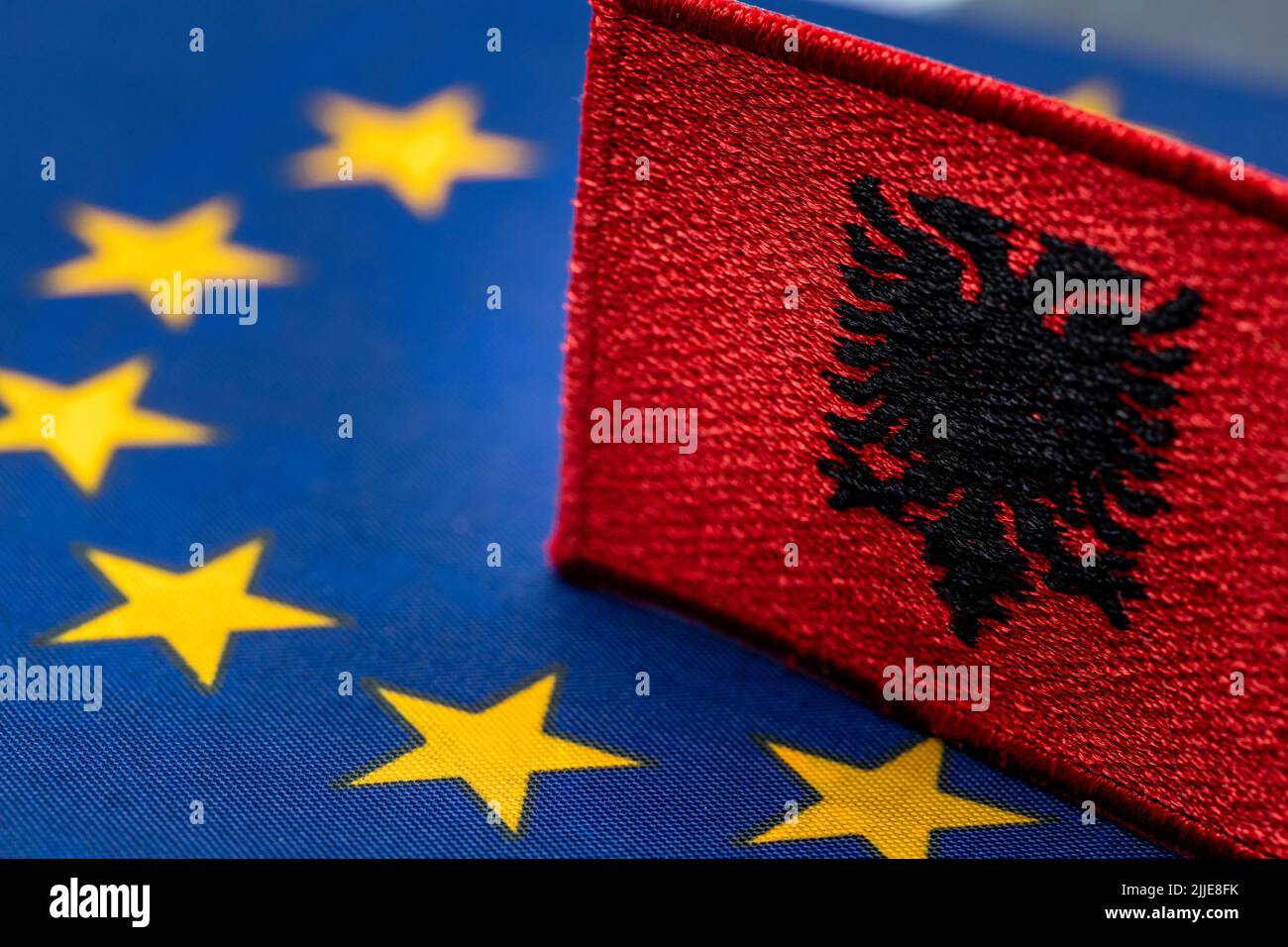 Die Flagge Albaniens vor dem Hintergrund des Symbols der Europäischen Union, das Konzept der Bereitschaft Albaniens, der Europäischen Gemeinschaft beizutreten Stockfoto