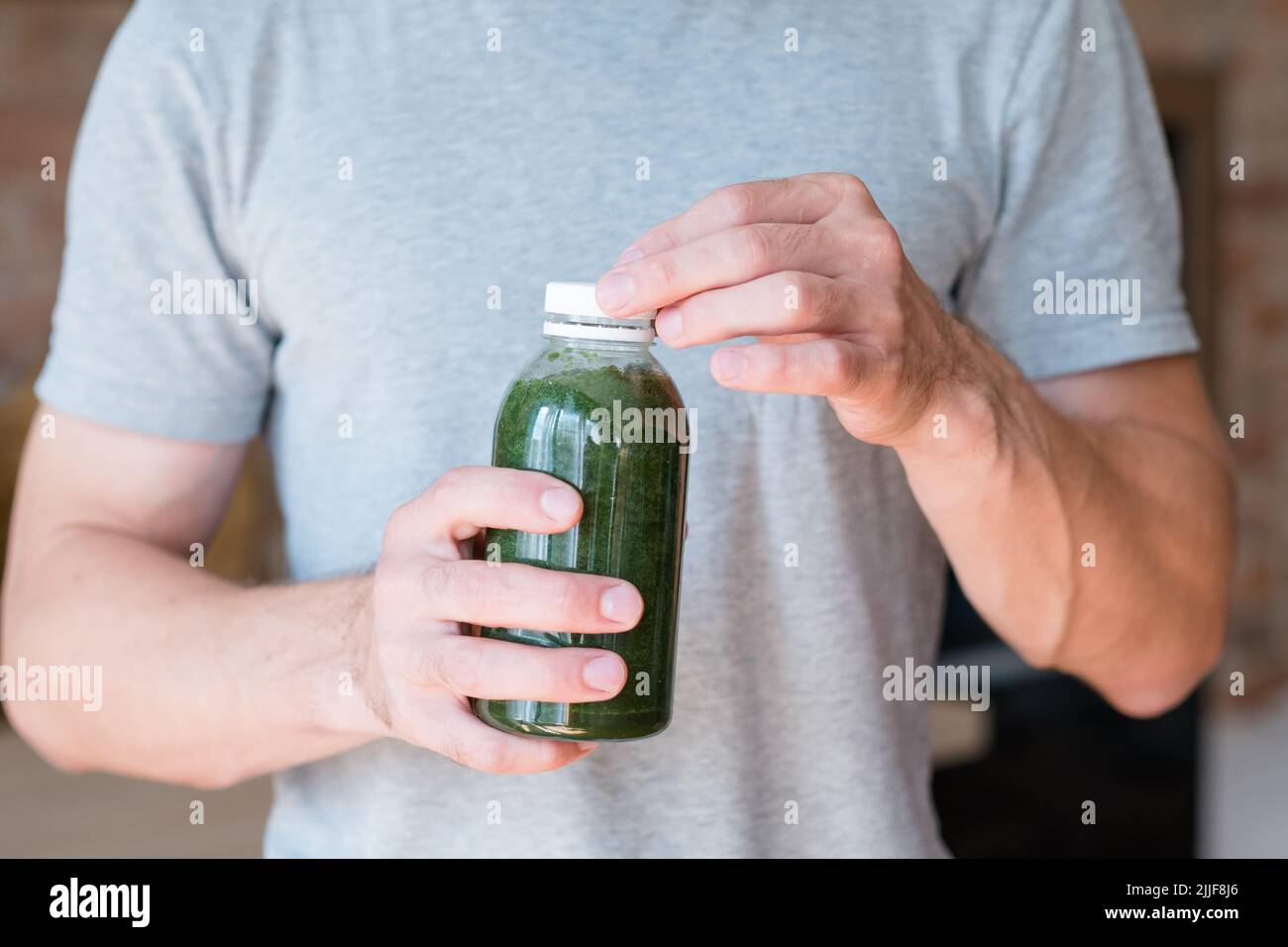 Mann halten Flasche grün Smoothie Detox trinken Gesundheit Stockfoto