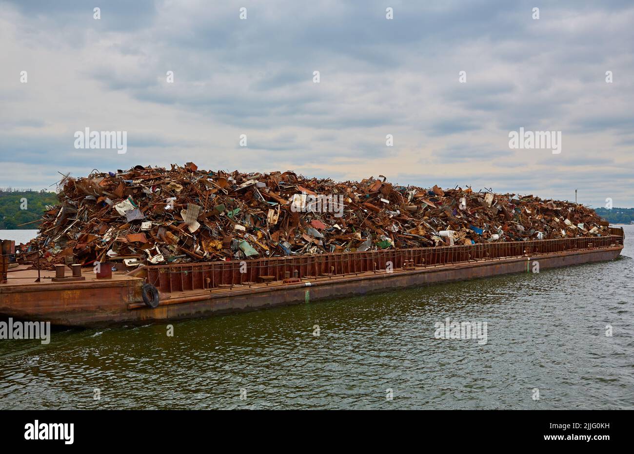 Transportindustrie. Schiffsbarge transportiert Schrott und Sand mit Kies Stockfoto