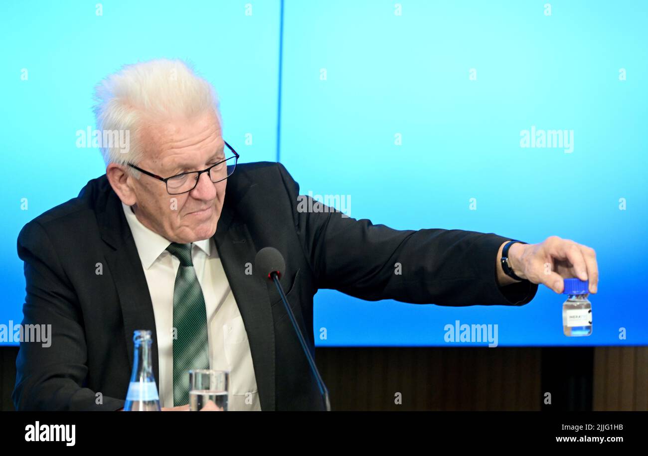 Stuttgart, Deutschland. 26.. Juli 2022. Winfried Kretschmann (Bündnis 90/die Grünen), Ministerpräsident von Baden-Württemberg, hält im Rahmen einer Regierungspressekonferenz im landtag eine Flasche reFuels (erneuerbare Kraftstoffe). Quelle: Bernd Weißbrod/dpa/Alamy Live News Stockfoto