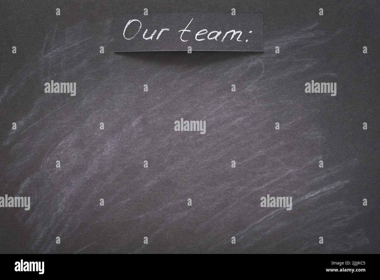 Unser Team schrieb schwarze Kreidetafel leeren Raum Stockfoto