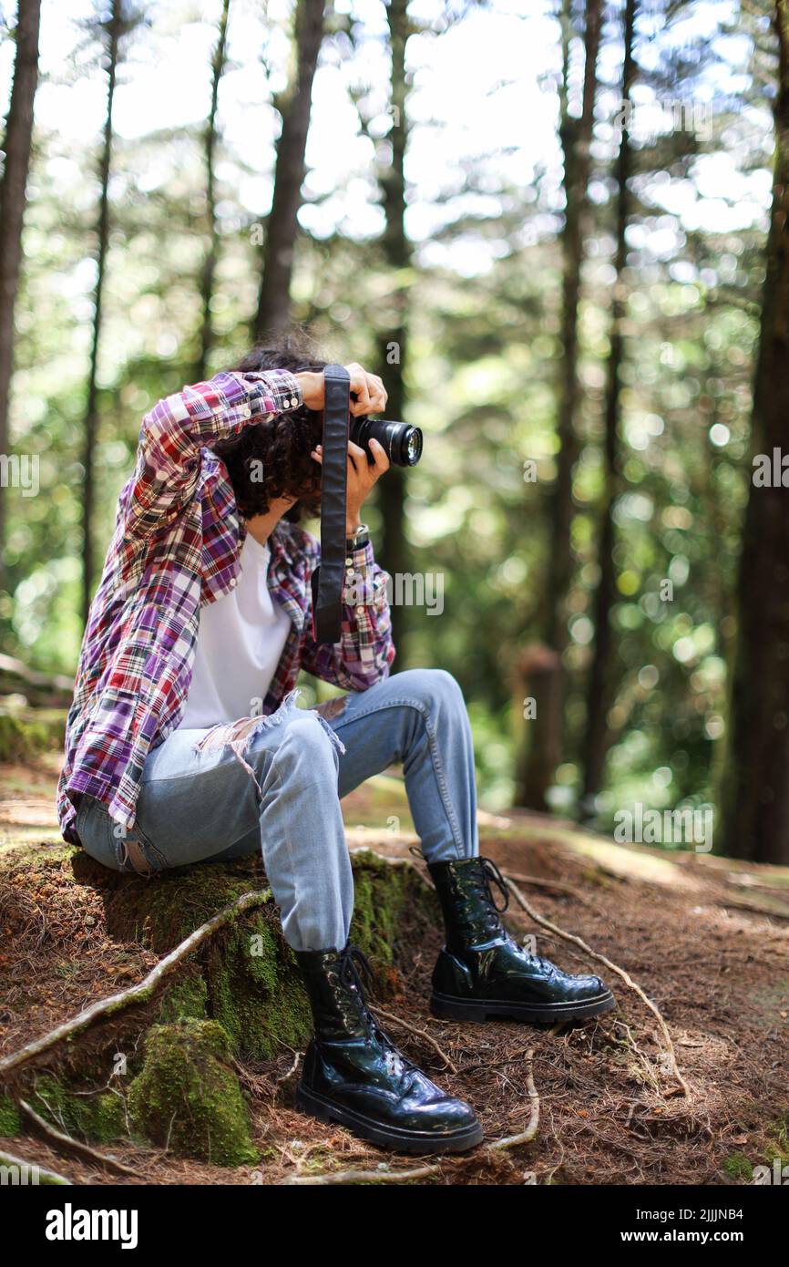 Gesichtslose Fotografin, die in Costa Rica mit der Kamera direkt in den Wald schaut Stockfoto