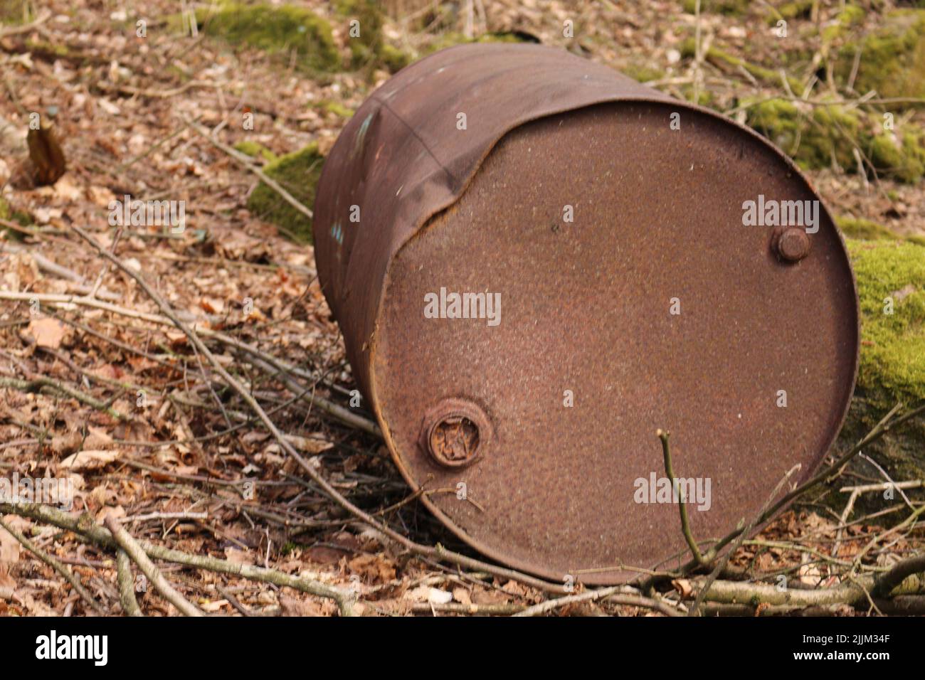 Eine Nahaufnahme eines rostigen mülls, der tagsüber auf einem Feld liegt Stockfoto