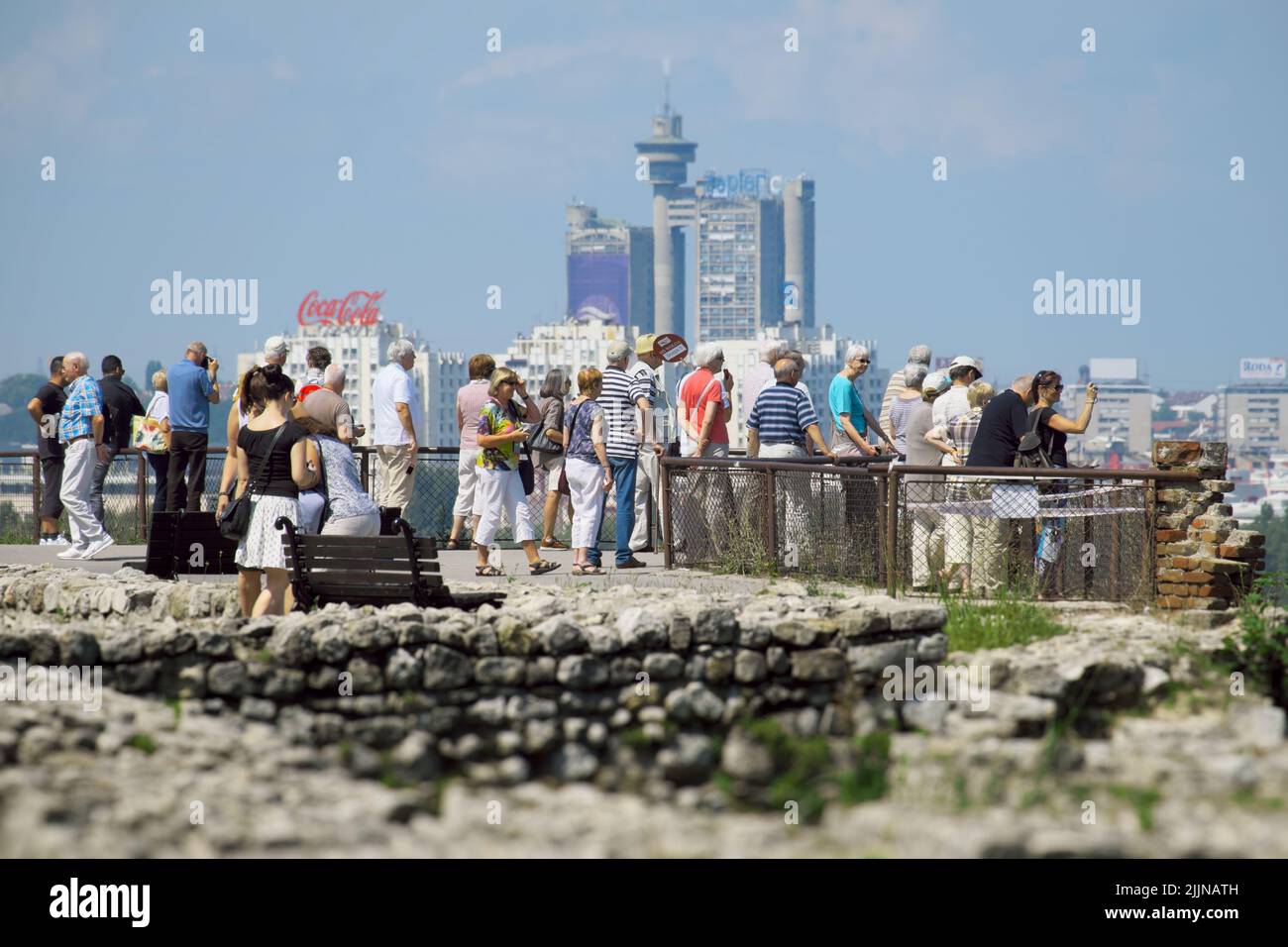 Reisegruppe in Belgrad, der Hauptstadt Serbiens, im Hintergrund verschwommene Wolkenkratzer und blauer Himmel Stockfoto