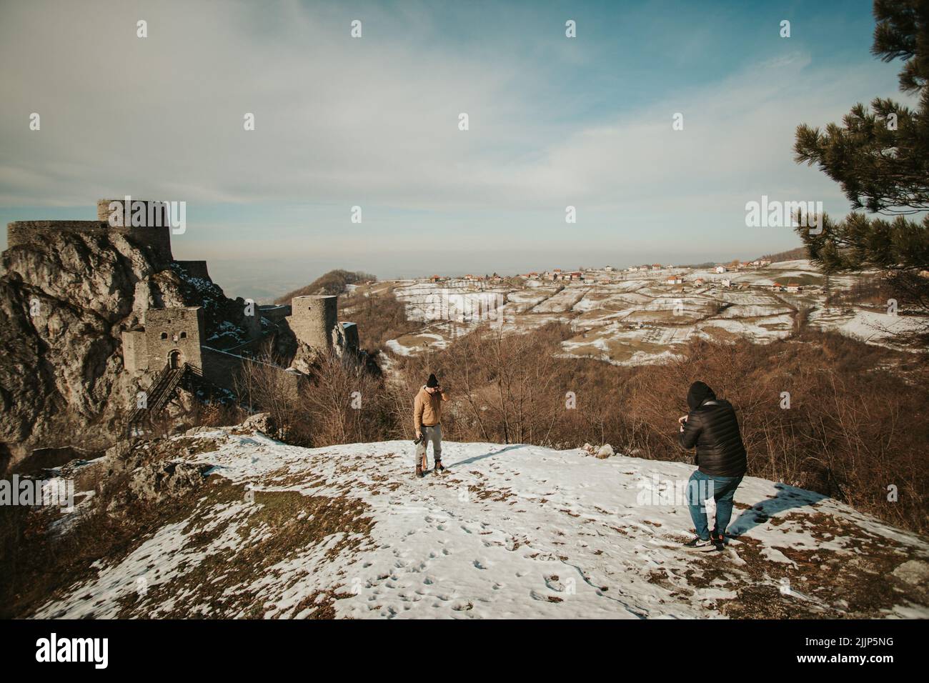 Ein Fotograf, der im Winter jemanden in der Natur fängt. Stockfoto