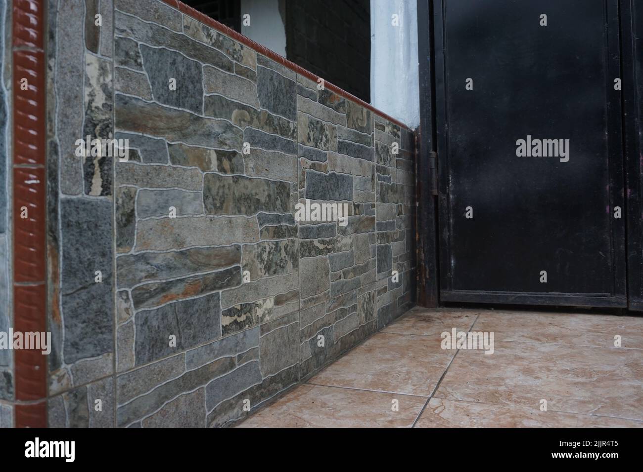 Eine Steinmauer in einem Hinterhof eines Hauses Stockfoto