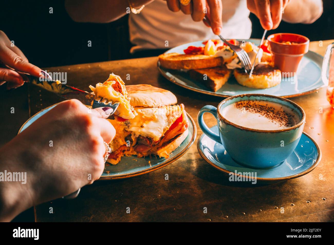 Das gesichtslose Paar, das in einem Restaurant mit Kaffee zu Mittag gegessen hat Stockfoto