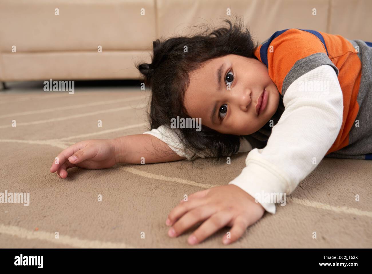 Entzückende kleine philippinische Kind auf dem Boden ruhen Stockfoto