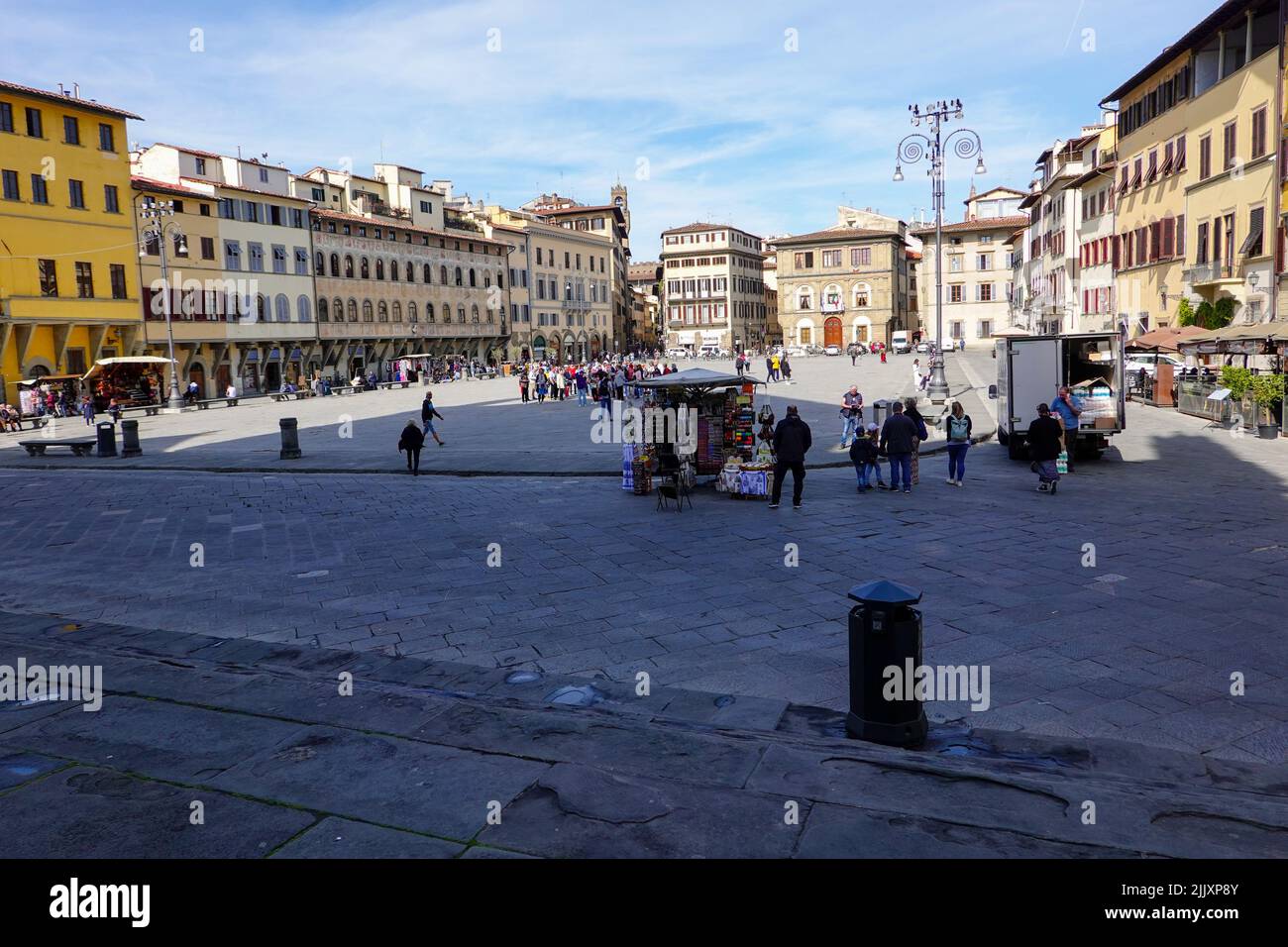 Menschen, die an einem angenehmen toskanischen Tag, Florenz, Italien, um die wunderschöne Piazza di Santa Croce herumlaufen. Stockfoto
