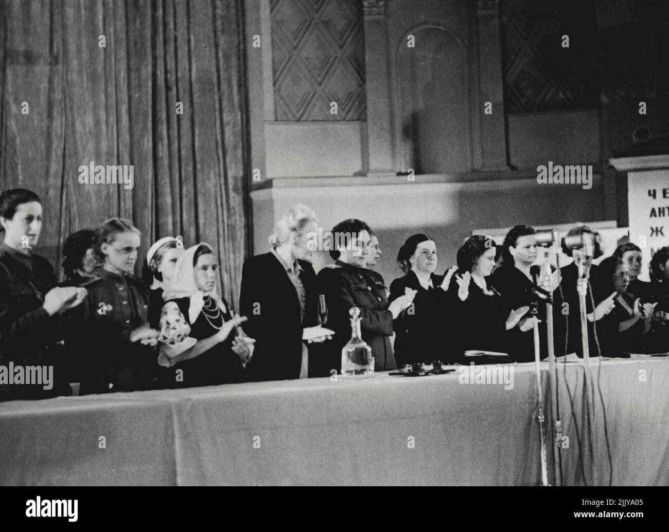 Viertes antifaschistisches Frauentreffen -- das vierte antifaschistische Frauentreffen der Sowjetunion fand am 20. August 1944 in der Tschaikowski-Konzerthalle in Moskau statt. Oben kommt das Präsidium des Treffens zu Applaus, als Natalie Uzhvy, Volkskünstlerin der UdSSR, ihre abschließenden Bemerkungen macht: "Ruhm und viele Jahre des Lebens für Marschall Stelin!" 3. September 1951. (Foto von M. Ozersky). Stockfoto