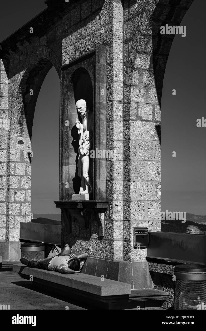 Ein entspannender Moment für einen Besuch eines Touristen im Kloster Montserrat, Provinz Barcelona, Spanien. Konzeptuelles Bild in Schwarzweiß. Stockfoto