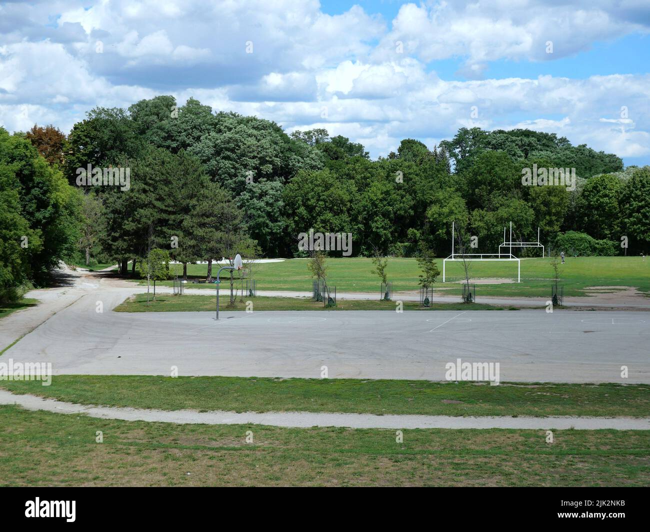Schulhof-Sportplatz mit Outdoor-Basketballnetz und Fußball- und Fußball-Torpfosten. Stockfoto