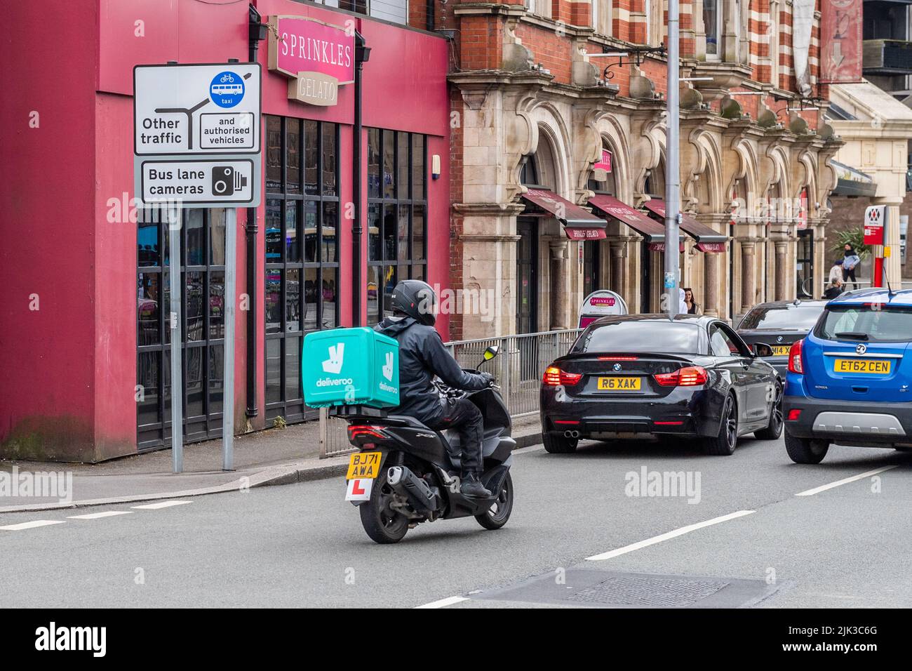Deliveroo Delivery Rider auf einem Roller, der Lebensmittel in Coventry, West Midlands, Großbritannien liefert. Stockfoto