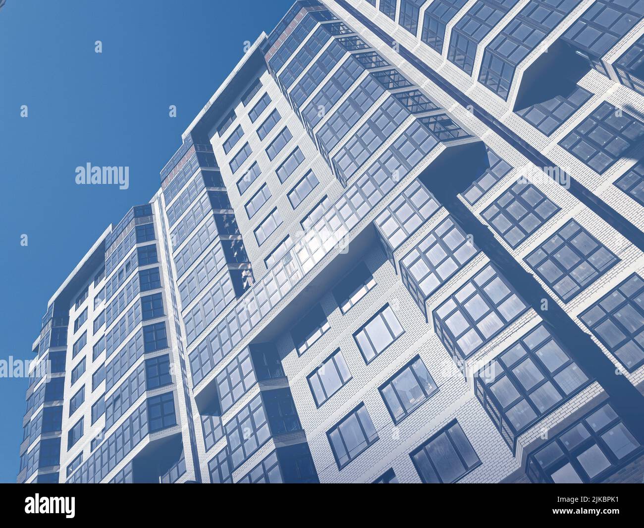 Abstraktes Äußeres eines modernen Wohngebäudes. Moderne Wohnarchitektur.getöntes blaues Bild. Stockfoto