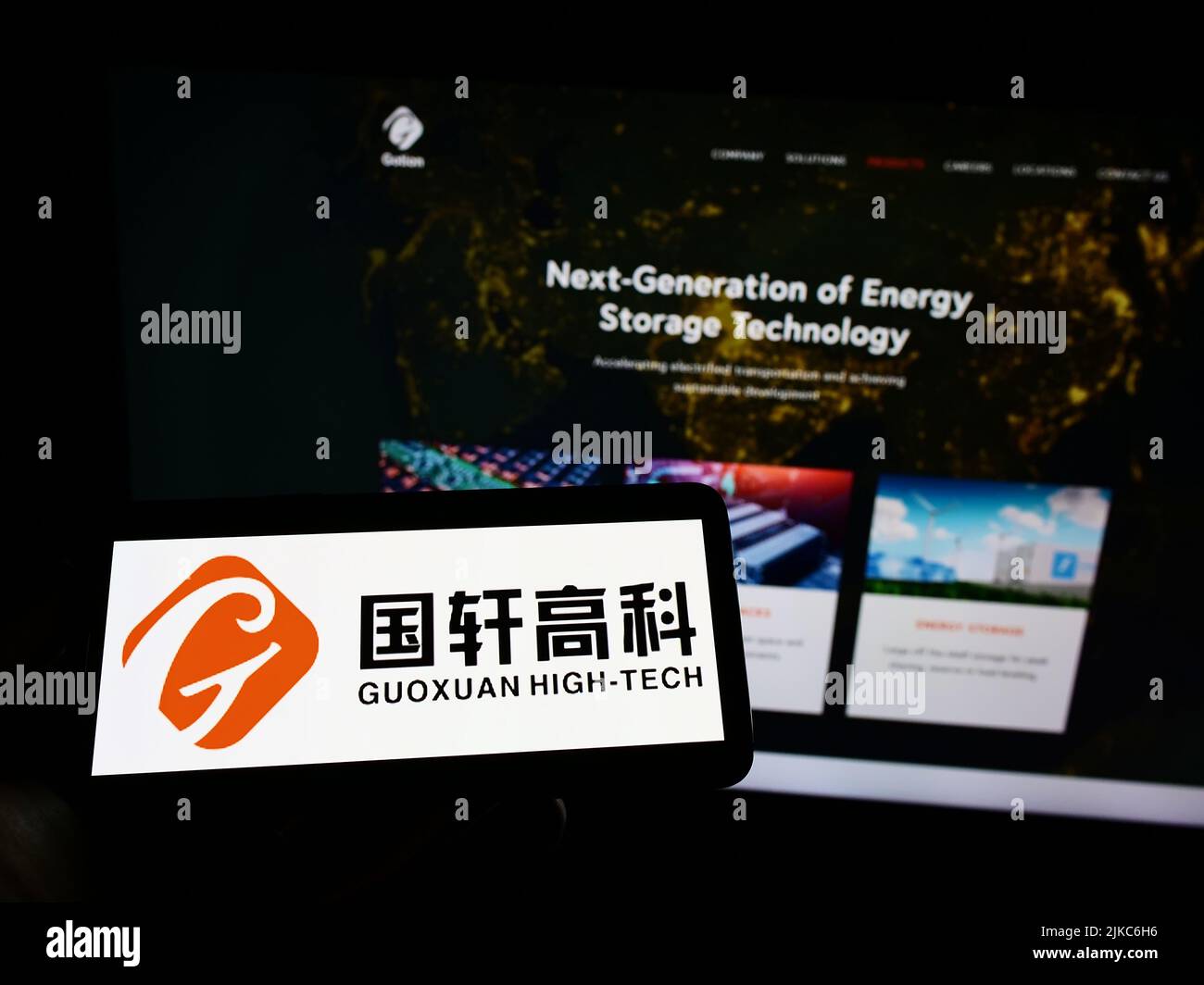 Person, die Mobiltelefon mit dem Logo des chinesischen Batterieunternehmens Gotion High-Tech auf dem Bildschirm vor der Business-Webseite hält. Konzentrieren Sie sich auf die Telefonanzeige. Stockfoto