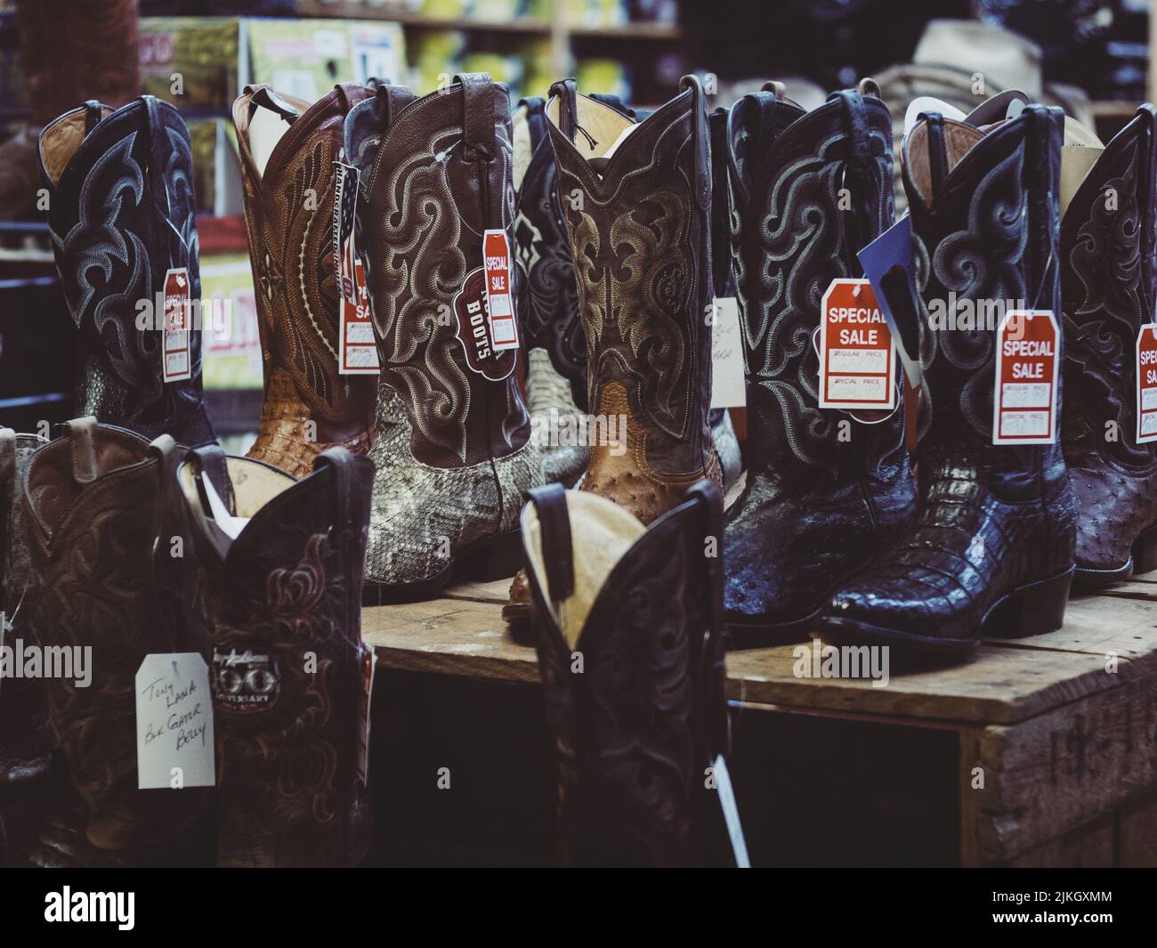 Eine Nahaufnahme von Cowboy-Stiefeln zum Verkauf mit Rabatt-Tags Stockfoto