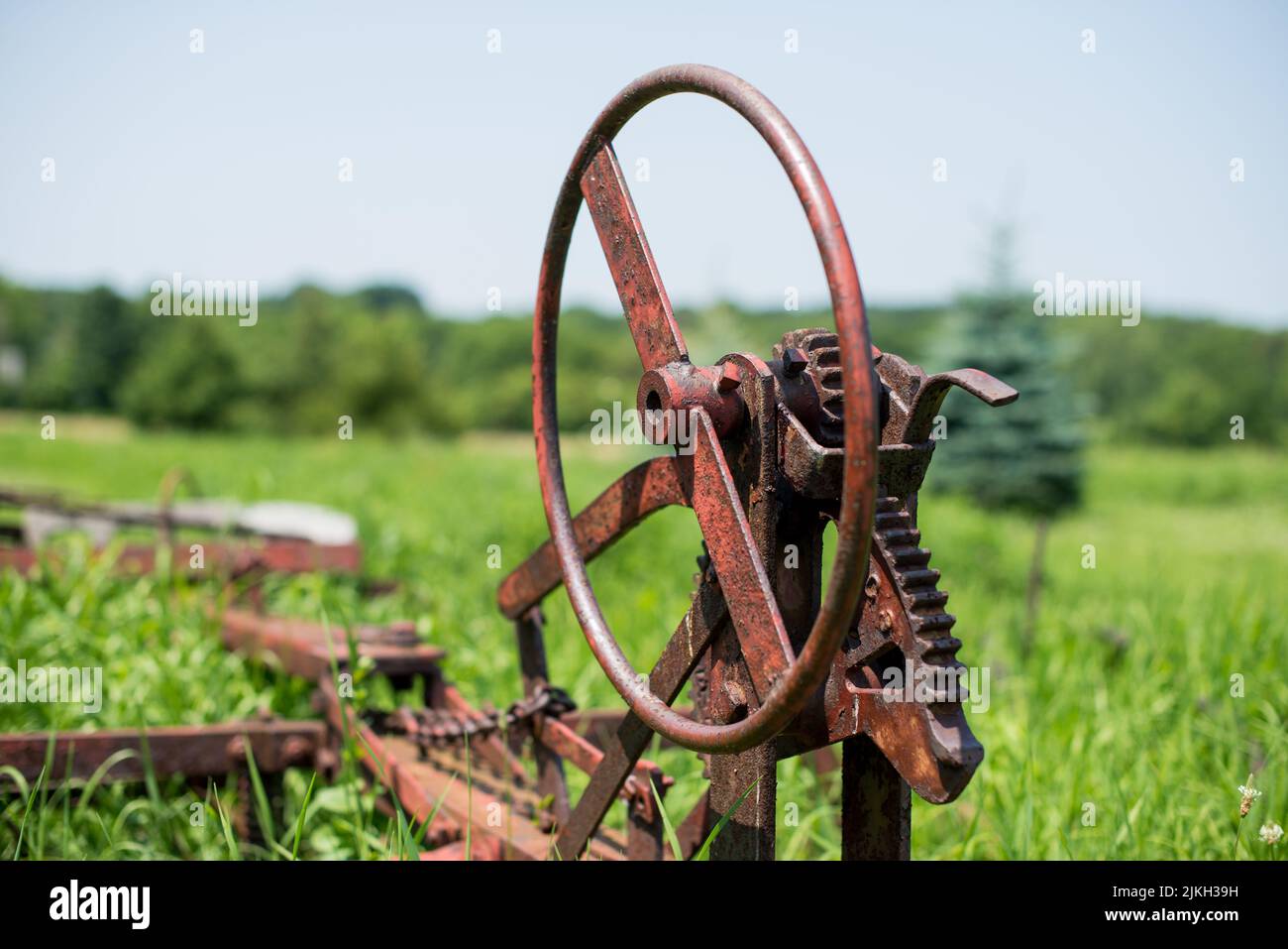 Nahaufnahme eines rostigen industriellen Rades auf einem Bauernhof Stockfoto