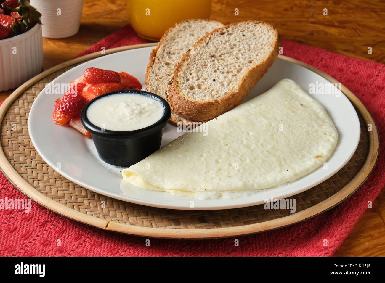 Ein Nahaufnahme eines gesunden Frühstücks mit Eiweiß, Brotscheiben und Erdbeeren Stockfoto