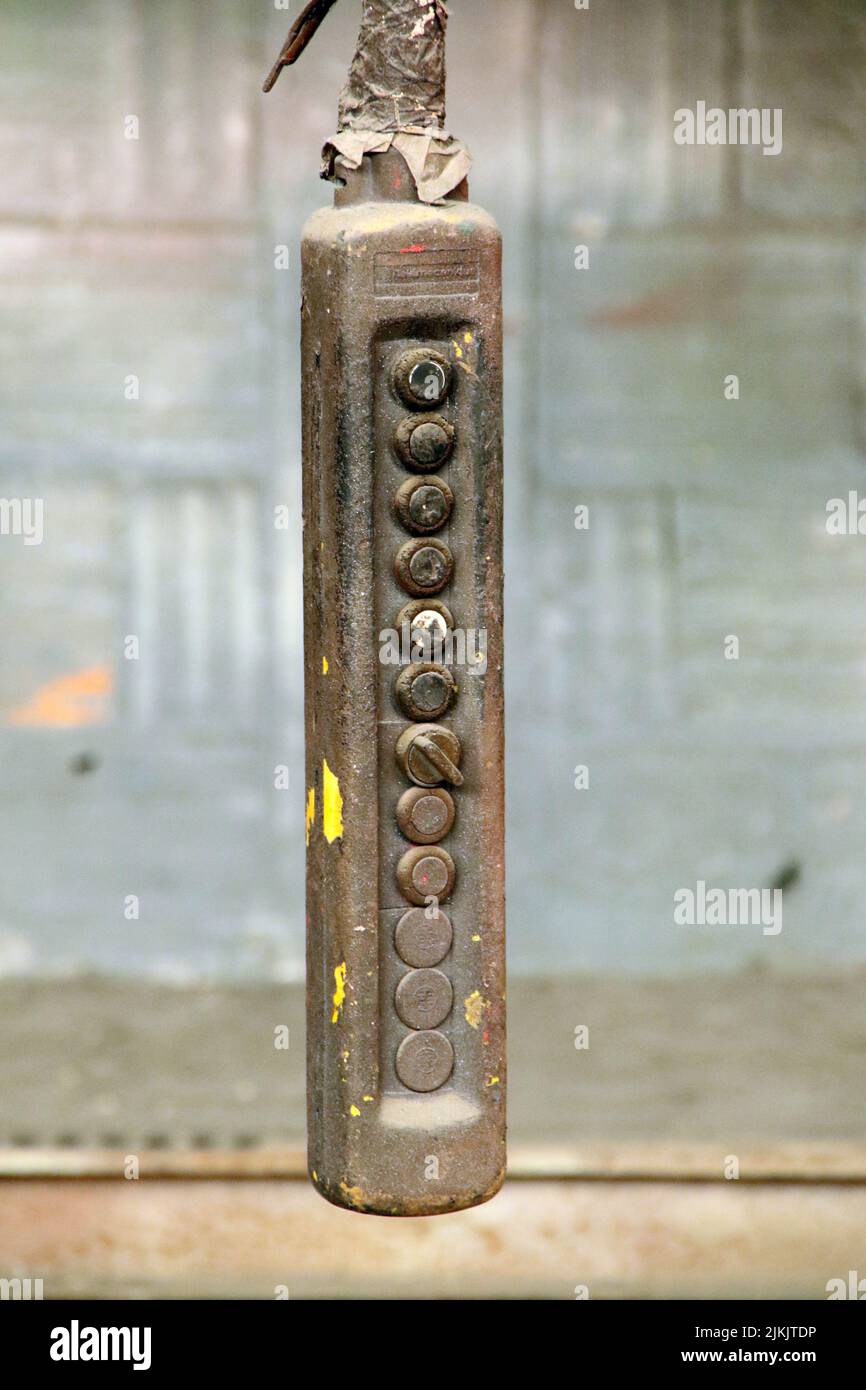 Eine selektive Fokusaufnahme eines Metallschalters, der an einem Draht hängt Stockfoto