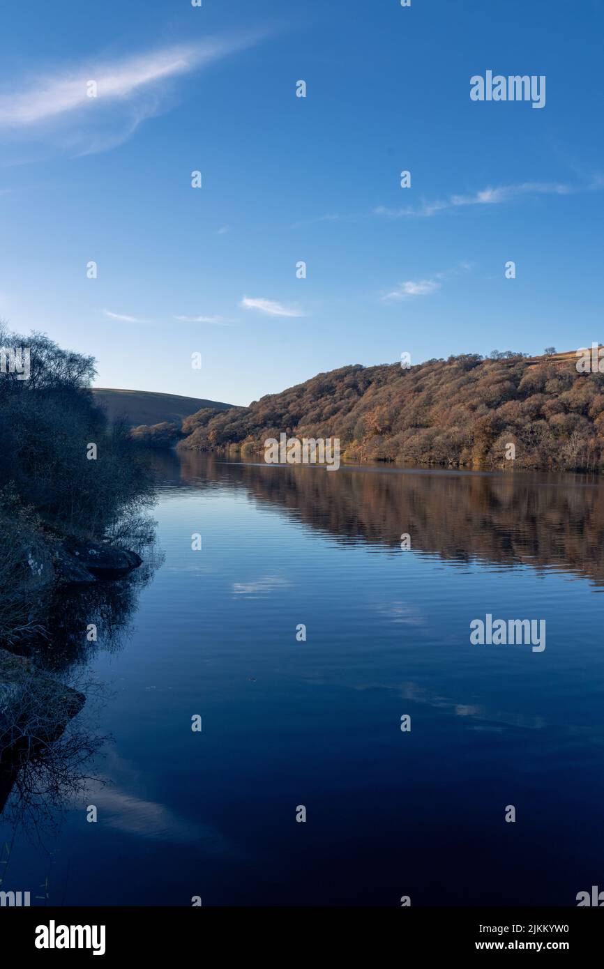 Eine vertikale Aufnahme der natürlichen Klippe mit der Reflexion im See Stockfoto