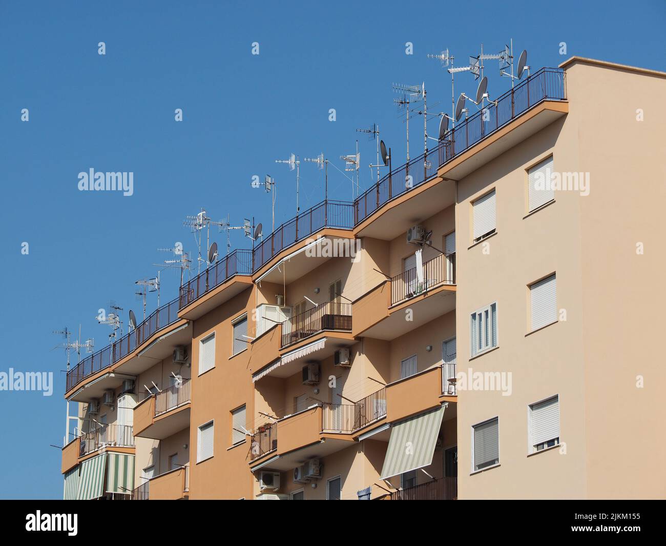 Viele Fernsehantennen und Satellitenschüsseln auf dem Dach eines Mehrfamilienhauses in Ercolano, Süditalien Stockfoto