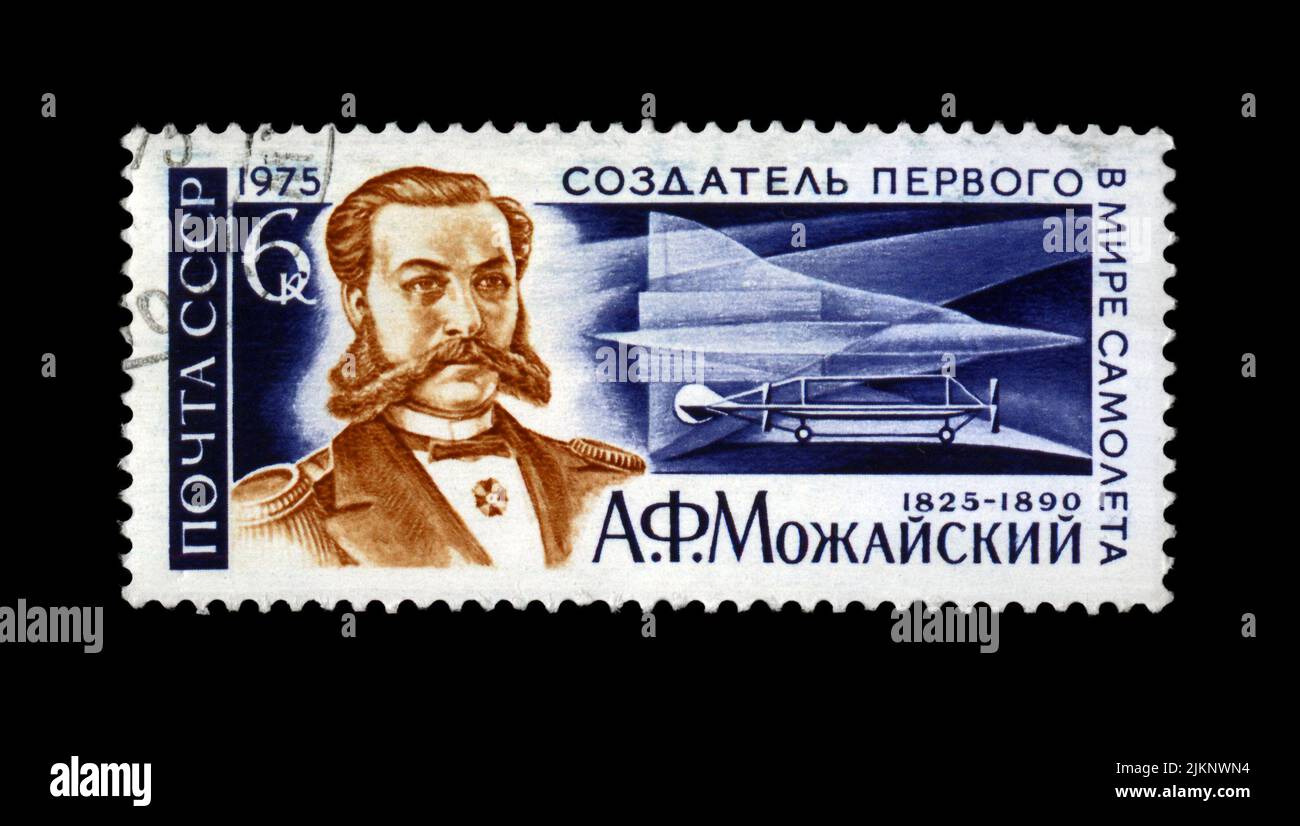 A. Mozhajski (1825-1890), frühes Flugzeug und Supersonic Jet TU-144, um 1975. Vintage Poststempel isoliert auf schwarzem Hintergrund. Stockfoto