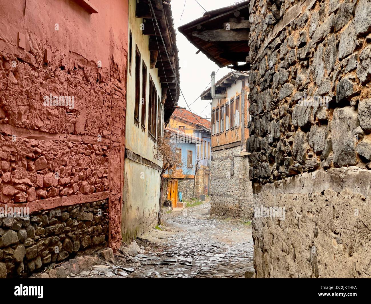 Eine schmale Steingasse durch historische Gebäude in Cumalikizik, Bursa, Türkei Stockfoto