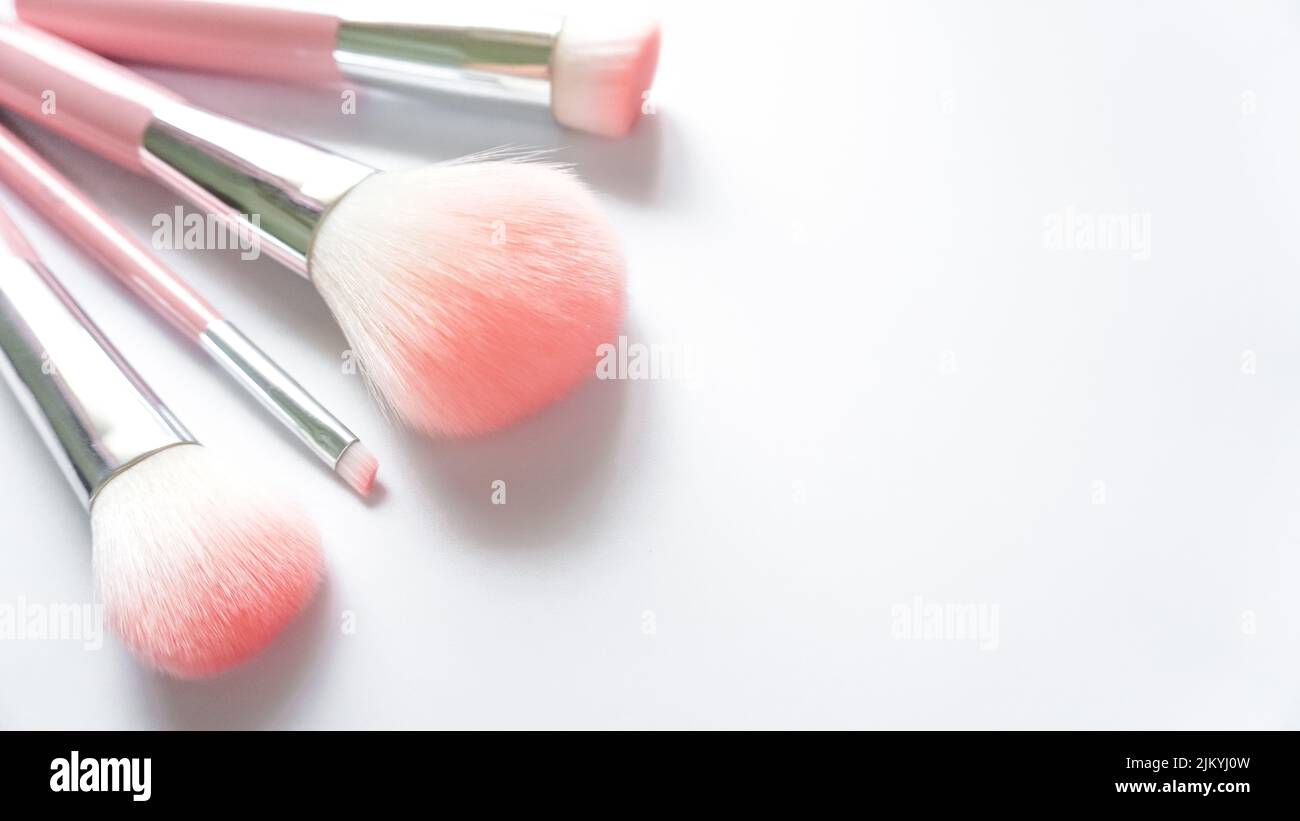 Eine Draufsicht auf mehrere rosa Make-up Pinsel auf weißem Hintergrund Stockfoto