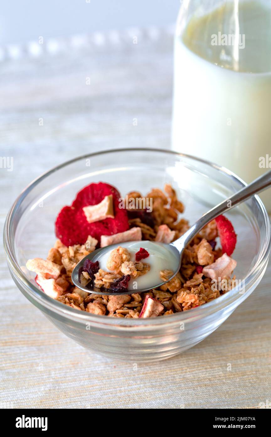Eine Schüssel Haferflocken mit einer Flasche Joghurt Stockfoto