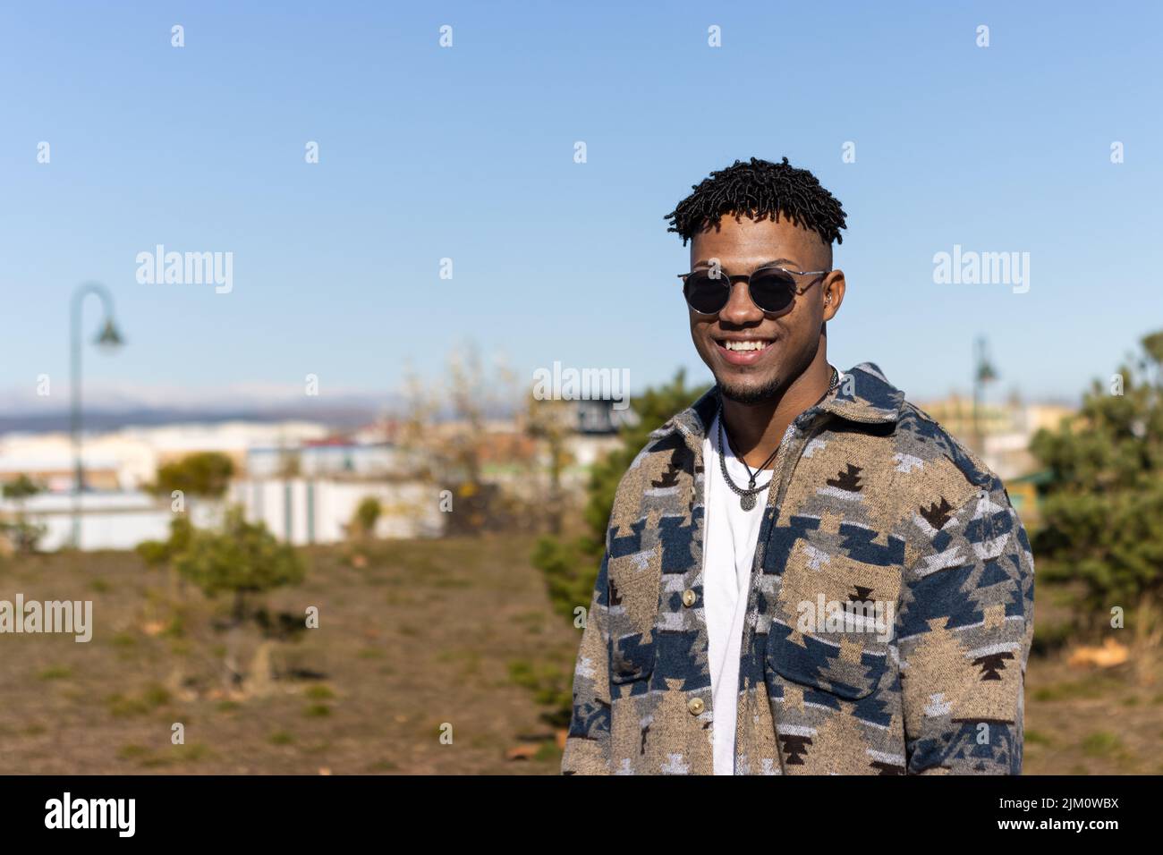 Porträt eines lächelnden Mannes, der im Sommer eine Sonnenbrille im Freien trägt Stockfoto